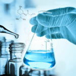 45720316 - flask in scientist hand and laboratory glassware background